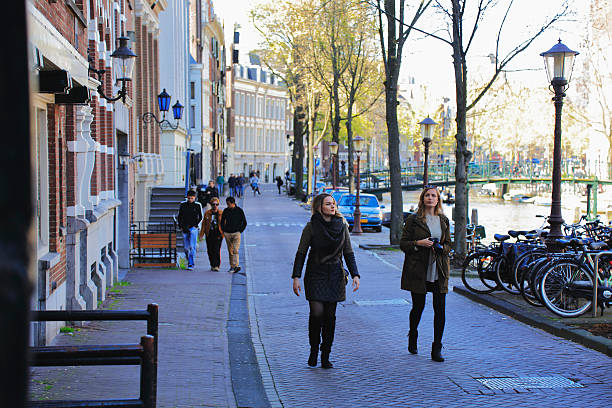 Comfortable pace walking on a tree-lined Amsterdam street